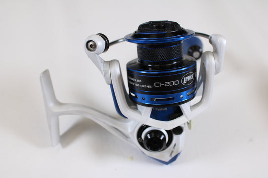 A close-up of a Lew's Custom Inshore CI-200 6.2:1 used spinning reel in good condition, featuring its spool, handle, and bail arm in silver and blue—ideal for anglers seeking quality pre-owned fishing gear.