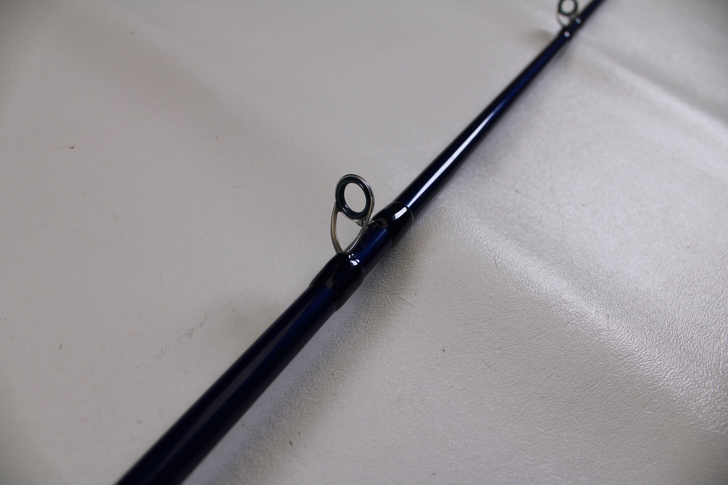 A close-up of the Douglas LRS C704M 7'0" Medium Casting Rod in excellent used condition highlights two line guides—ideal for anglers trading in gear and earning store credit with our Rod and Reel Trade-In Program.