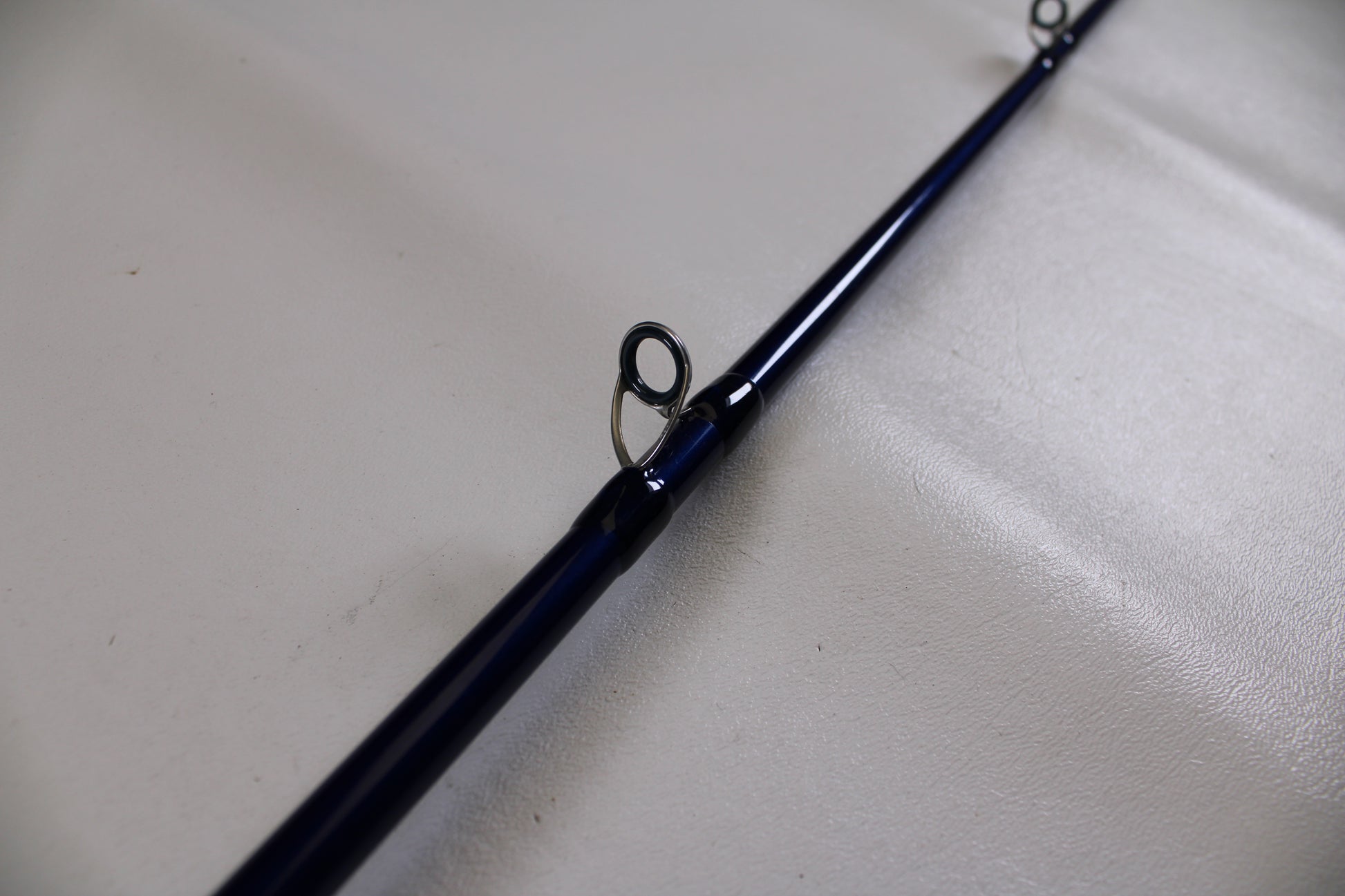 A close-up of the Douglas LRS C704M 7'0" Medium Casting Rod in excellent used condition highlights two line guides—ideal for anglers trading in gear and earning store credit with our Rod and Reel Trade-In Program.