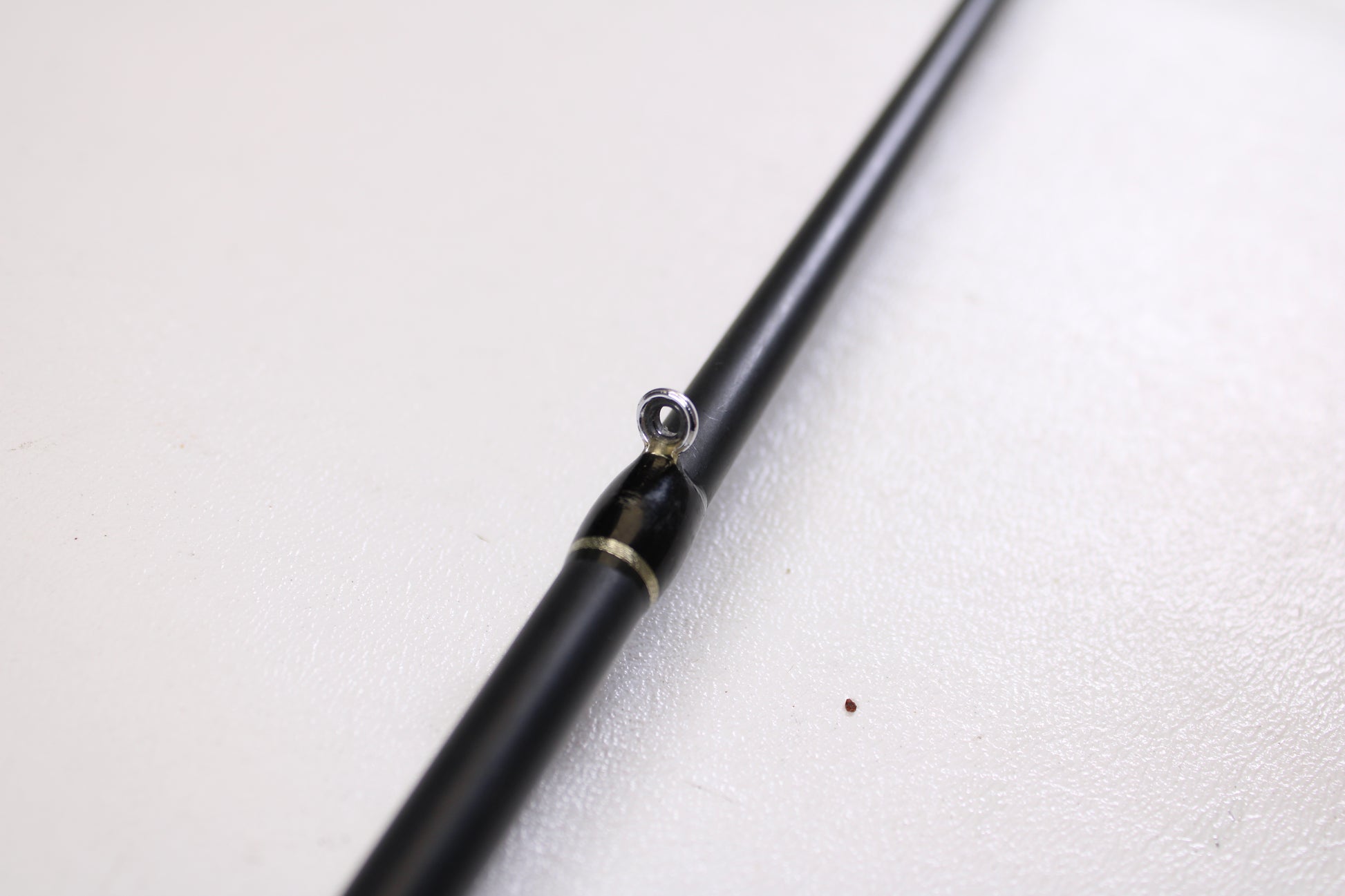 Close-up of a Fitzgerald Bryan Thrift TCB74H 7'4" Heavy Crankbait casting rod in good used condition, highlighting a metal guide ring—ideal for those joining our Rod and Reel Trade-In Program to upgrade or earn store credit.