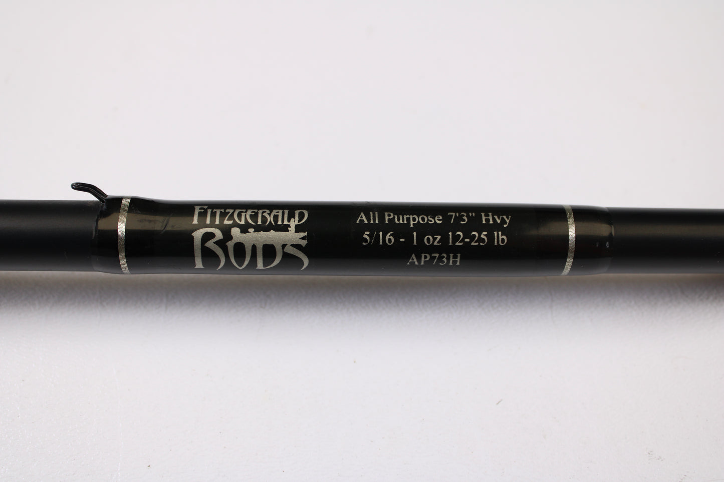 Close-up of a Fitzgerald AP73H 7'3" Heavy Used Casting Rod in very good condition, featuring silver bands and a hook keeper—ideal for anyone using store credit or trading in used gear.