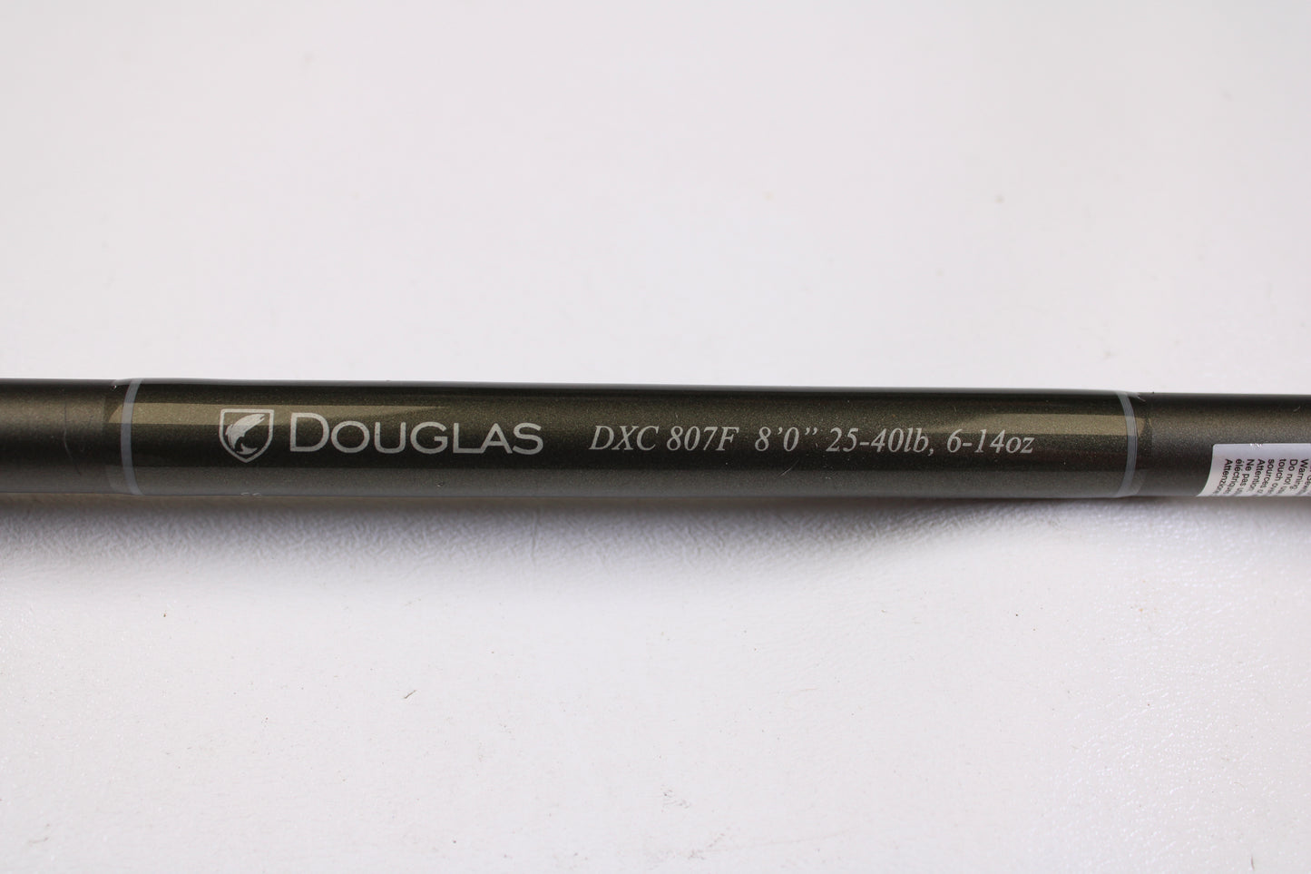 A close-up of the Douglas XMatrix DXC 807F 8'0" Extra Heavy Used Casting Rod in excellent condition displays “Douglas” branding—ideal for anyone interested in our rod and reel trade-in program.