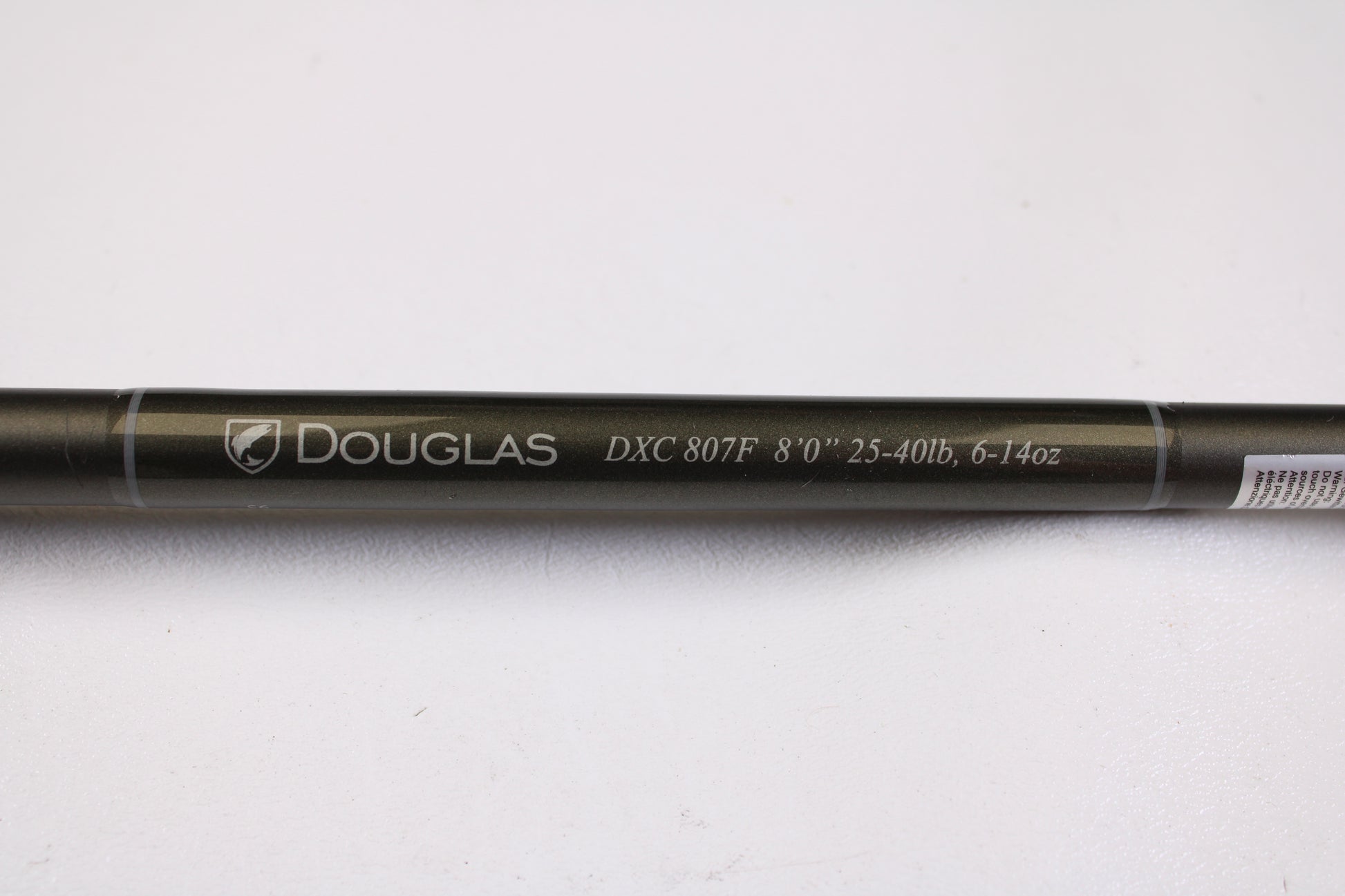 A close-up of the Douglas XMatrix DXC 807F 8'0" Extra Heavy Used Casting Rod in excellent condition displays “Douglas” branding—ideal for anyone interested in our rod and reel trade-in program.