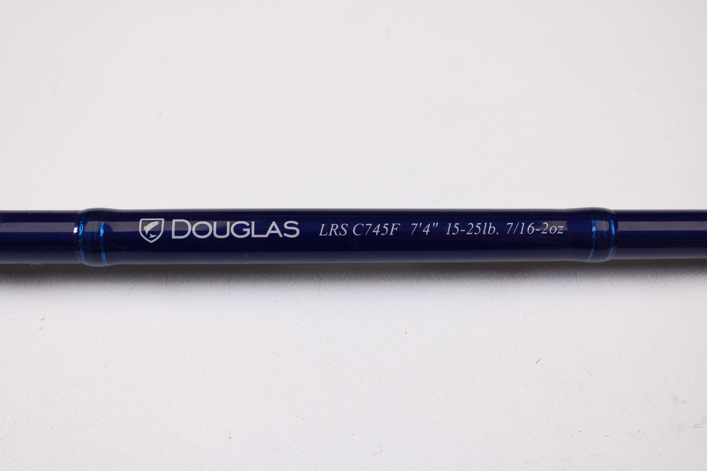 A close-up of a Douglas LRS C745F 7'4" Medium Heavy used casting rod in excellent condition, with clear model lettering, shown on a white background—perfect for those interested in used gear or our rod and reel trade-in program.