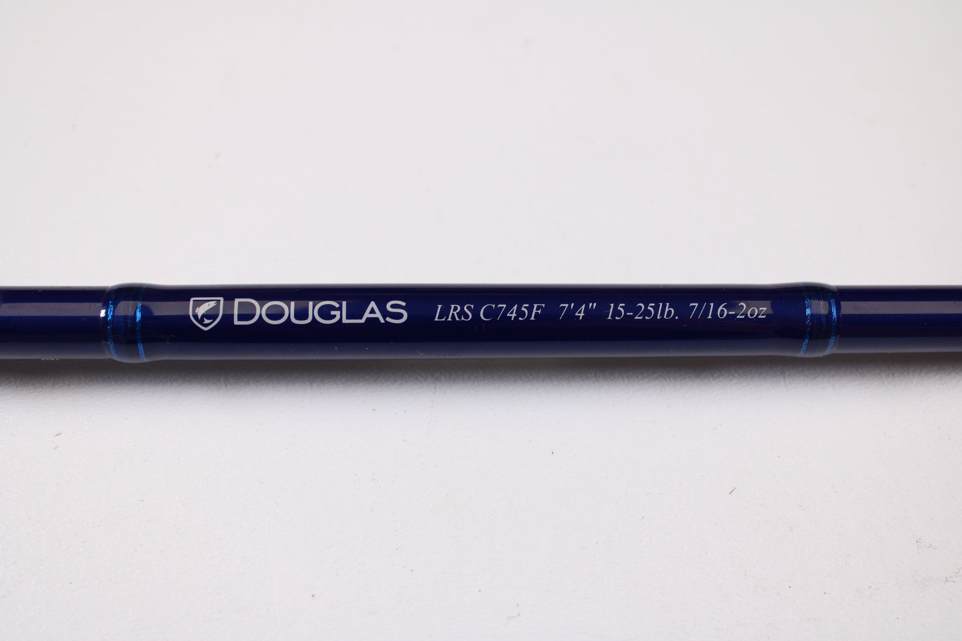 A close-up of a Douglas LRS C745F 7'4" Medium Heavy used casting rod in excellent condition, with clear model lettering, shown on a white background—perfect for those interested in used gear or our rod and reel trade-in program.