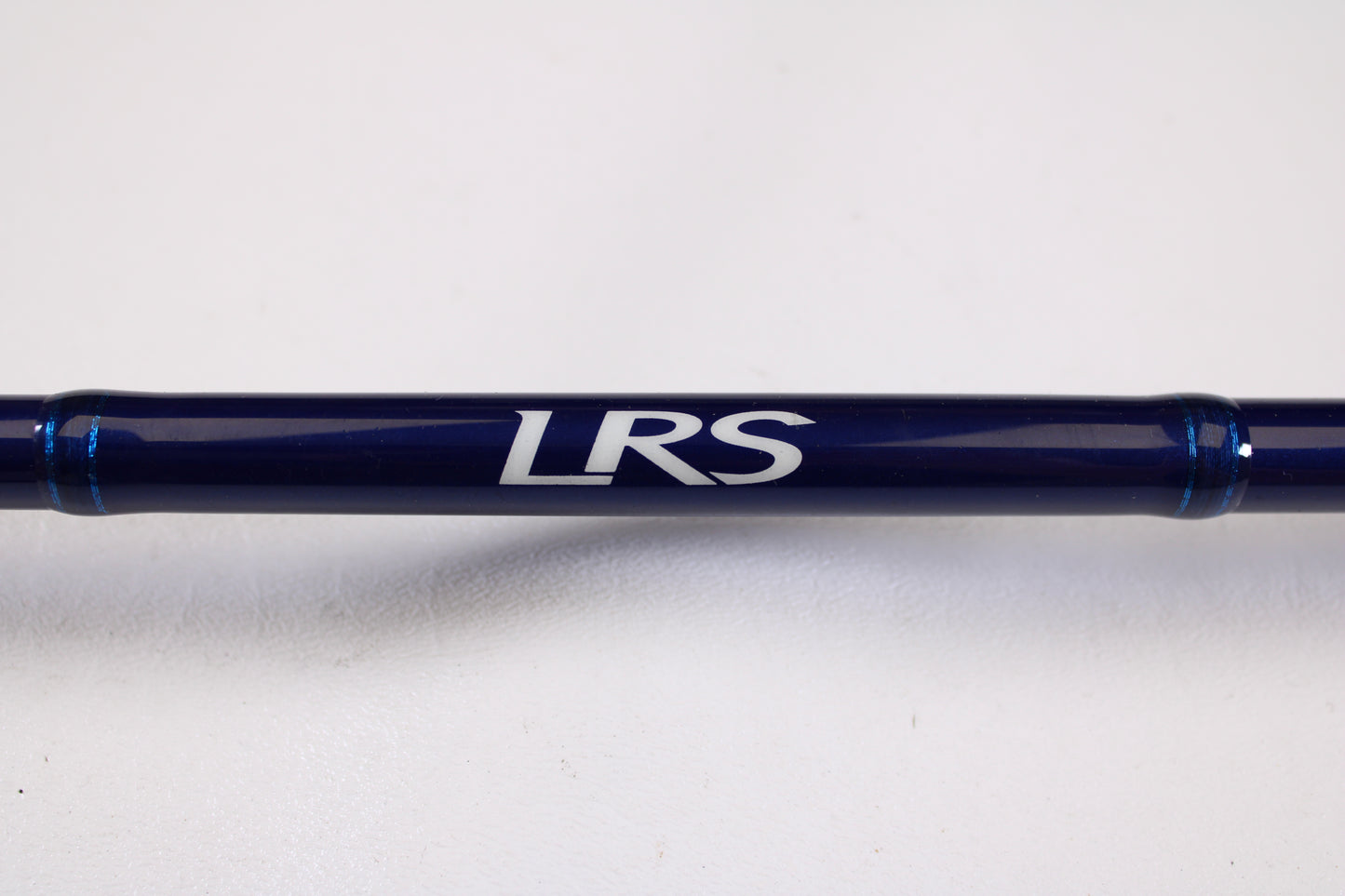 A close-up of the Douglas LRS C745F 7'4" Medium Heavy Used Casting Rod in excellent condition, with "LRS" in white on its dark blue blank—ideal for rod and reel trade-in—set against a plain white background.