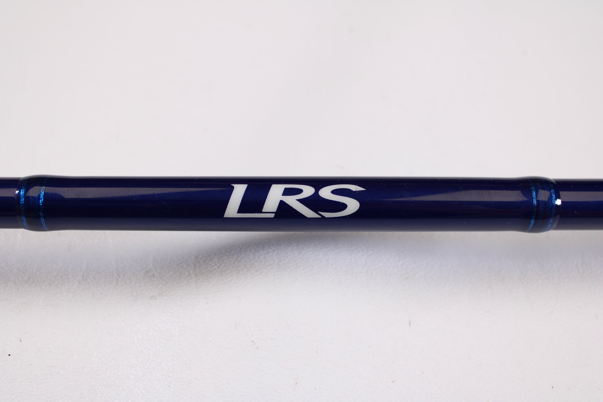 A close-up of the Douglas LRS C745F 7'4" Medium Heavy Used Casting Rod in excellent condition, with "LRS" in white on its dark blue blank—ideal for rod and reel trade-in—set against a plain white background.