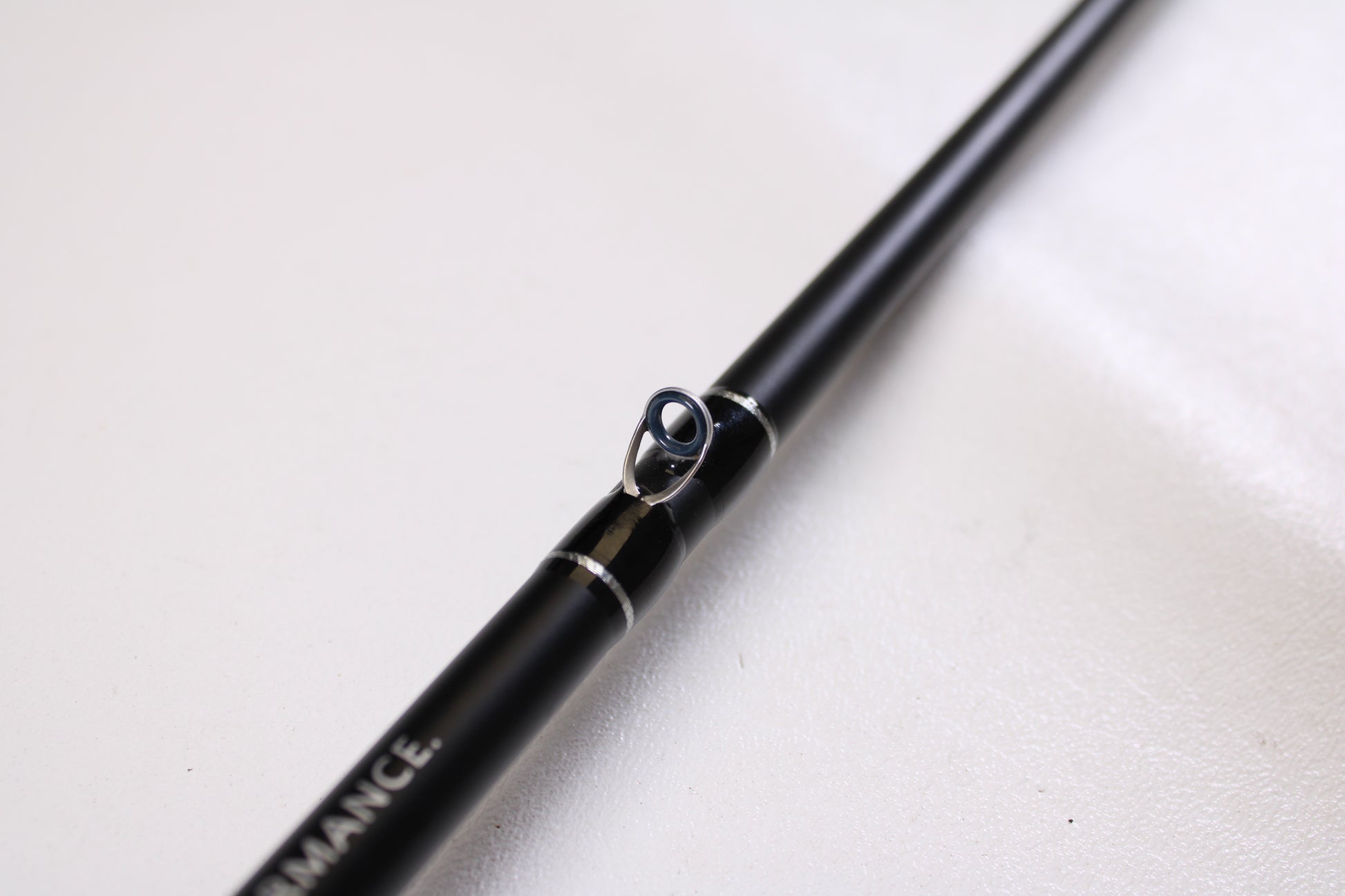Close-up of an FXtreme Angler Series WSB69MHXF 6'9" Medium Heavy casting rod in very good condition, showing a metal line guide and "PERFORMANCE." text—ideal for trade-in to earn store credit for used FXtreme gear.