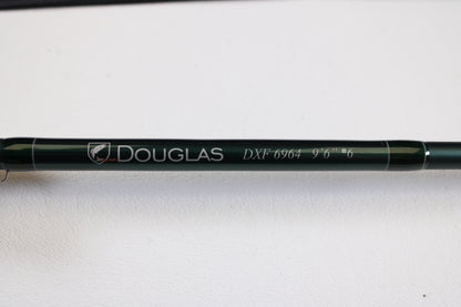 A close-up of a Douglas DXF Gen 1 6964 9'6" 6wt 4pc Used Fly Rod in excellent condition, shown on a white surface—ideal for those interested in our rod and reel trade-in program for store credit.