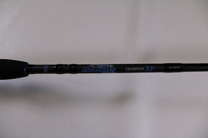 Close-up of a Dobyns Champion XP DC795SB used casting rod handle in excellent condition, featuring blue and silver accents—ideal for our rod and reel trade-in program. Upgrade your fishing gear for store credit. Plain white background.
