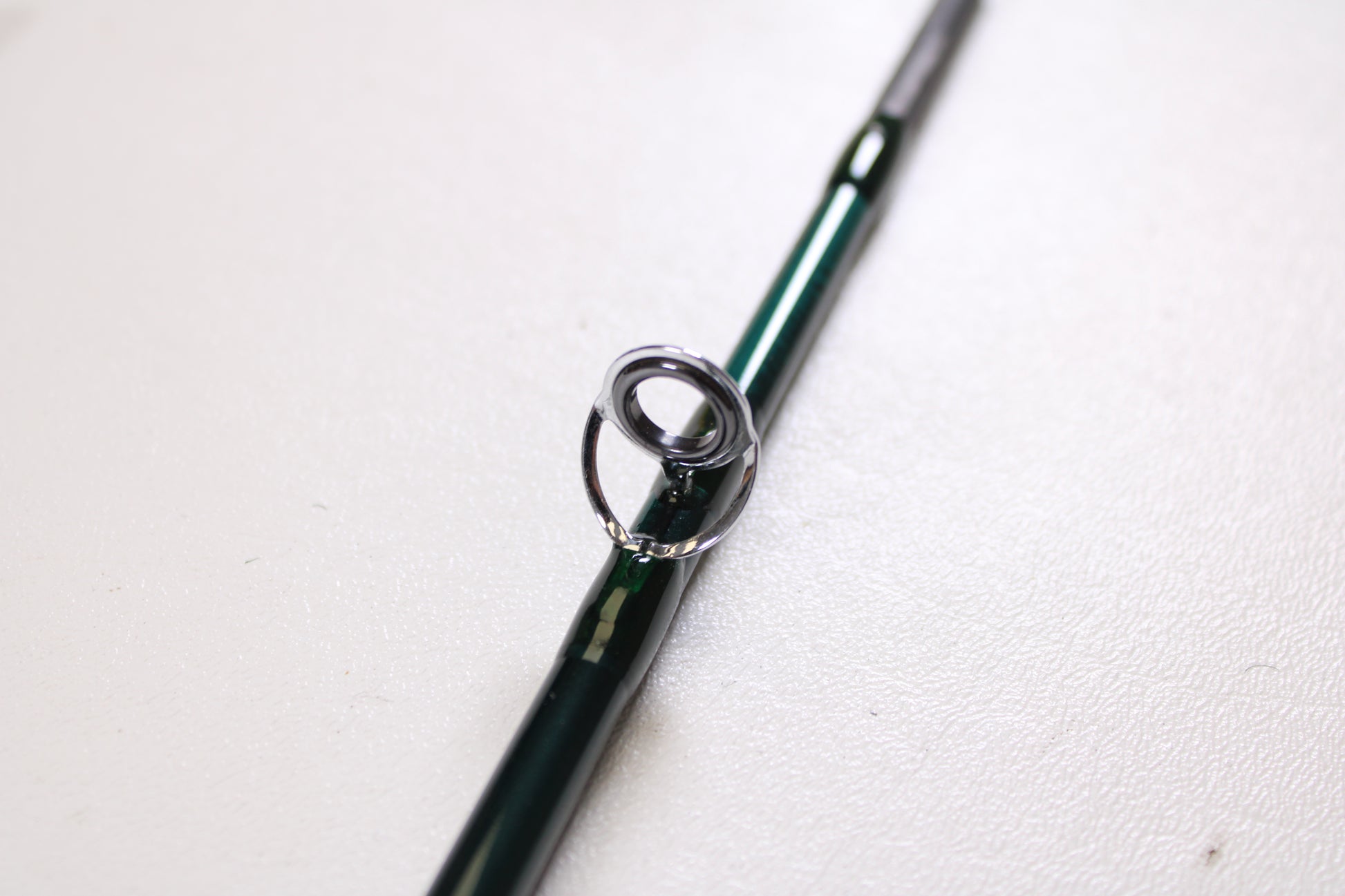 A close-up of the Orvis Frequent Flyer 908 9'0" 8 7pc Used Fly Rod in excellent condition by Sage, highlighting a metal line guide—ideal for those exploring our Rod and Reel Trade-In Program for store credit.