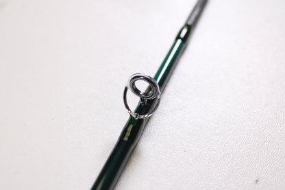 A close-up of the Orvis Frequent Flyer 908 9'0" 8 7pc Used Fly Rod in excellent condition by Sage, highlighting a metal line guide—ideal for those exploring our Rod and Reel Trade-In Program for store credit.
