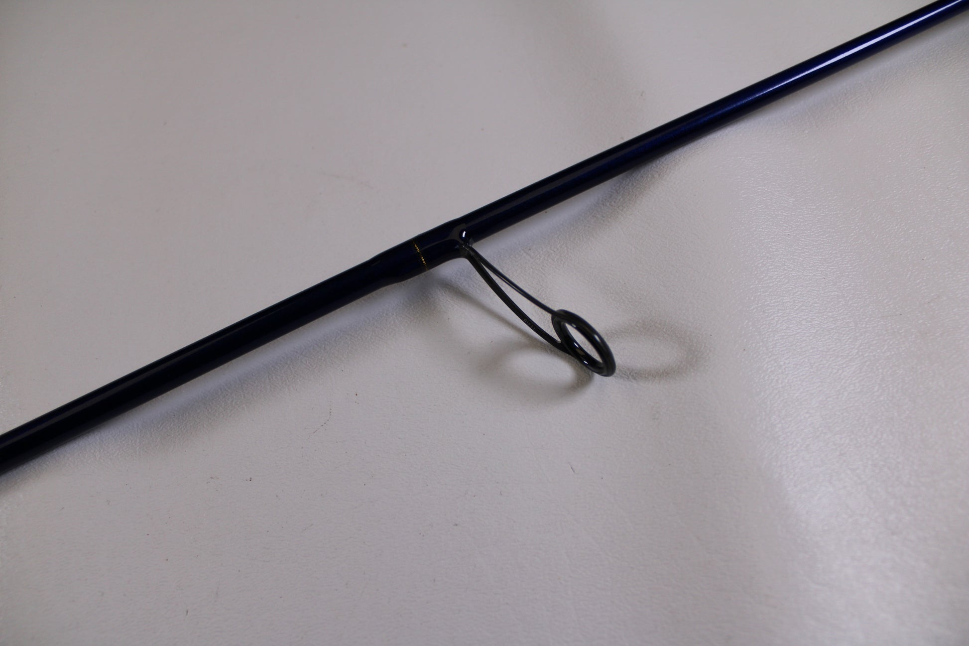 A close-up of a St. Croix Legend Tournament Walleye LWTS66MF Used Spinning Rod in excellent condition, highlighting a line guide—ideal for trading in your gear with our Rod and Reel Trade-In Program.