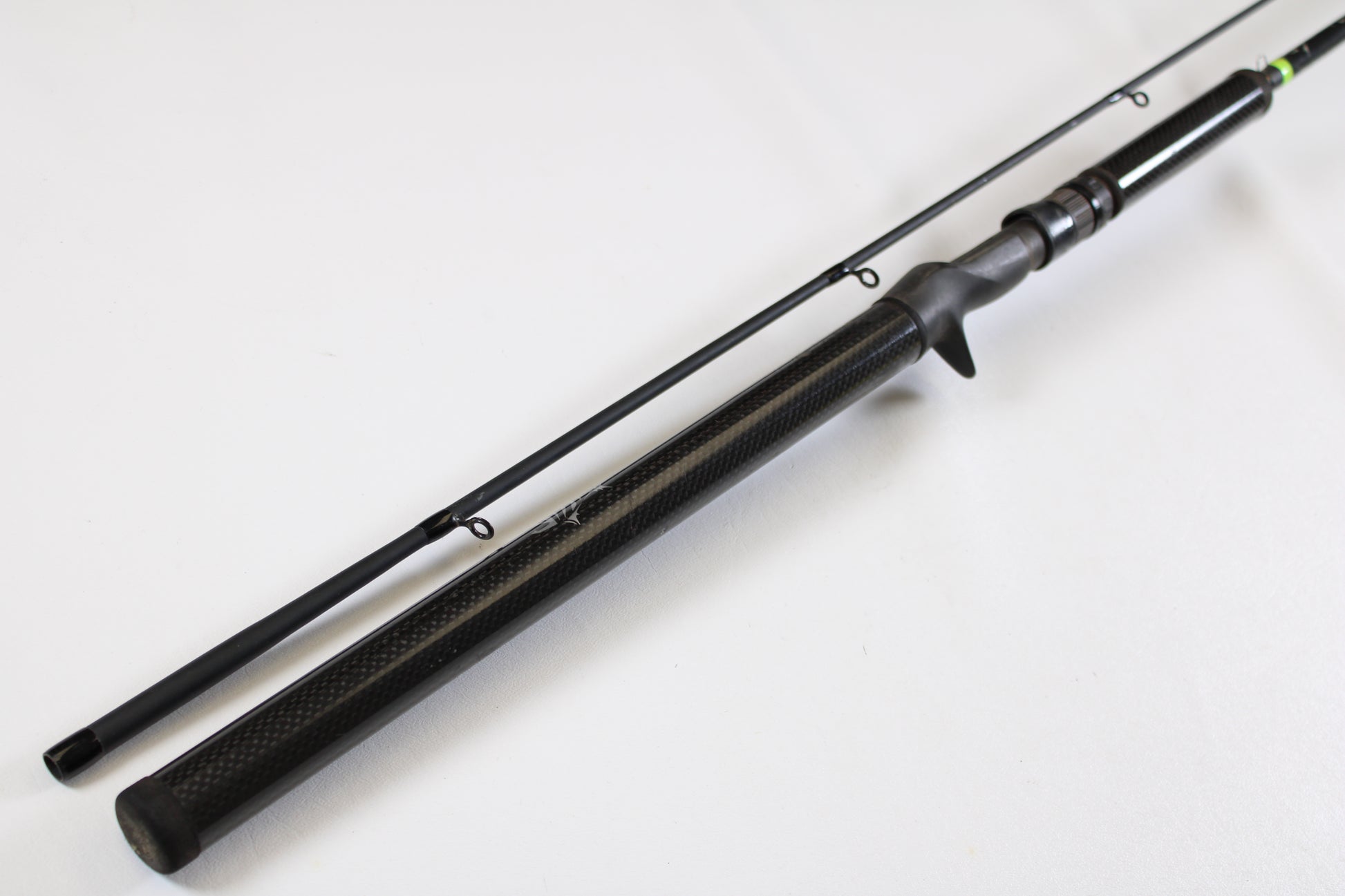 The G. Loomis E6X Hot Shot 1021-2C HSR GH 8'6" Mag Medium 2pc Casting Rod (Used, Good Condition) features a black finish with a textured handle and two visible line guides—ideal for our rod and reel trade-in program.