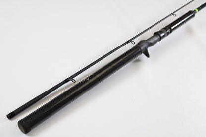 The G. Loomis E6X Hot Shot 1021-2C HSR GH 8'6" Mag Medium 2pc Casting Rod (Used, Good Condition) features a black finish with a textured handle and two visible line guides—ideal for our rod and reel trade-in program.