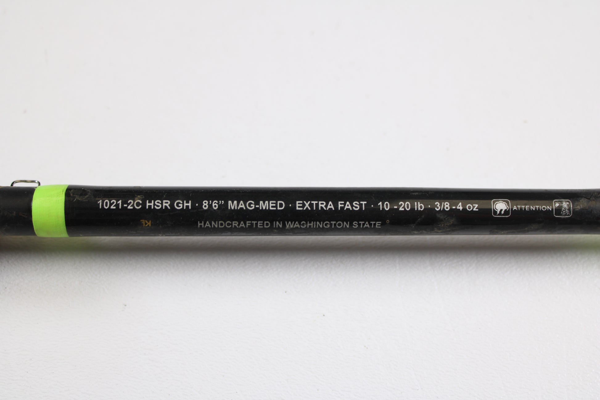 Close-up of a G. Loomis E6X Hot Shot 1021-2C HSR GH 8'6" Mag Medium 2pc used casting rod in good condition, featuring white specs and "HANDCRAFTED IN WASHINGTON STATE"—ideal for trade-ins or buying with store credit.