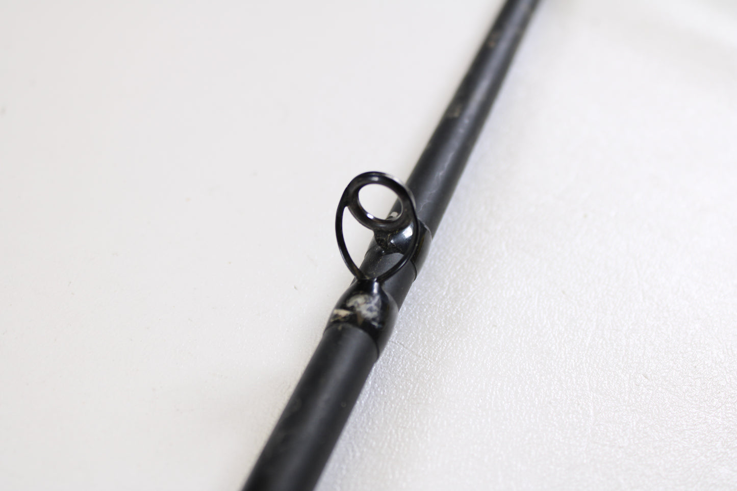 Close-up of a G. Loomis E6X Hot Shot 1021-2C HSR GH 8'6" Mag Medium 2pc Used Casting Rod guide—ideal for upgrading via our rod and reel trade-in program or exchanging used G. Loomis gear for store credit.