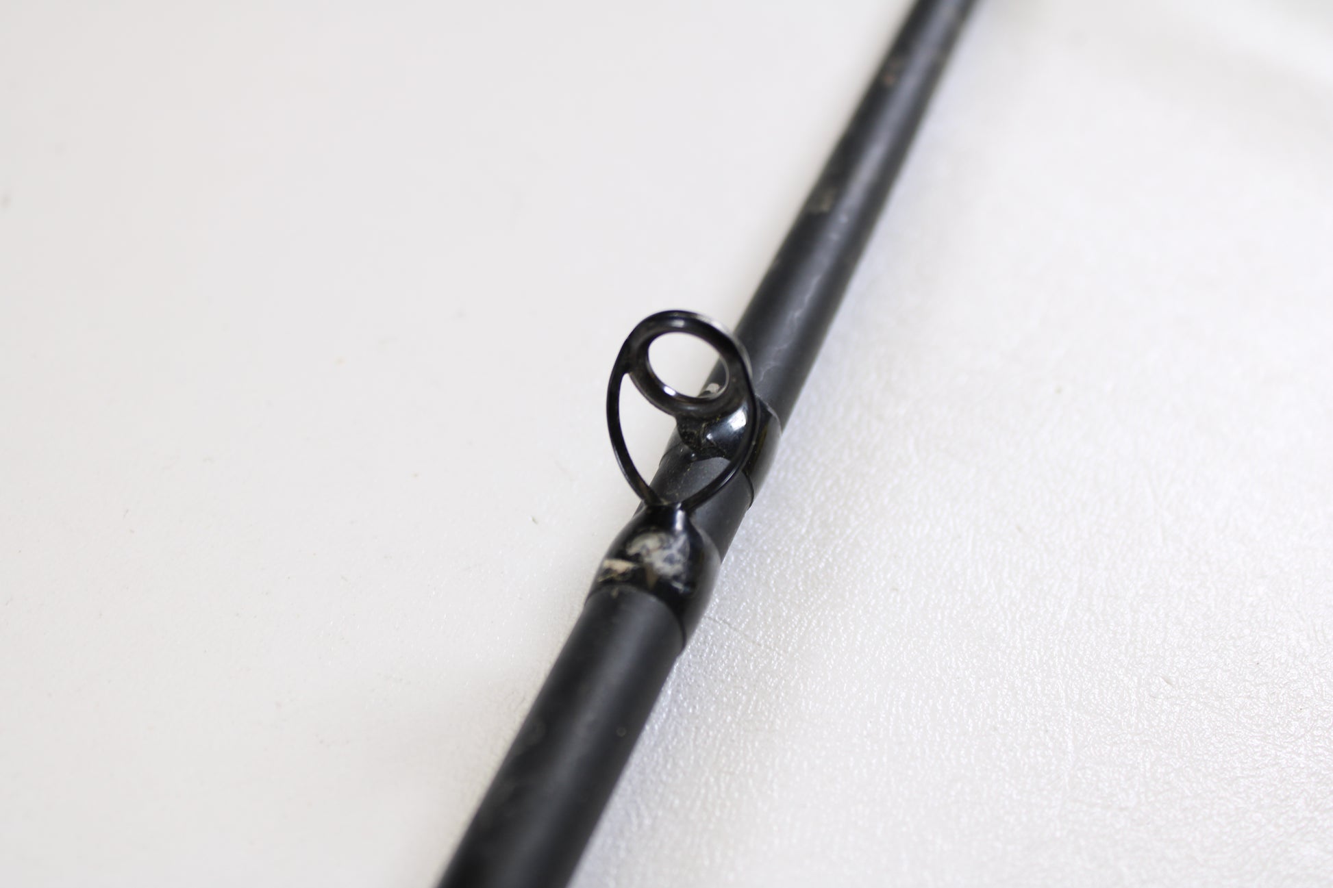 Close-up of a G. Loomis E6X Hot Shot 1021-2C HSR GH 8'6" Mag Medium 2pc Used Casting Rod guide—ideal for upgrading via our rod and reel trade-in program or exchanging used G. Loomis gear for store credit.
