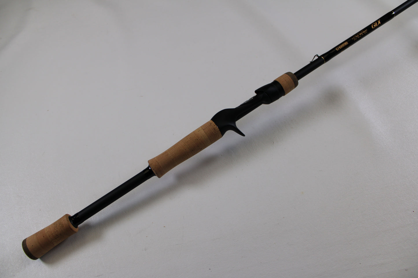 The G. Loomis GLX 873c BJR 7'3" Medium Heavy Used Casting Rod is shown—an excellent-condition black rod with cork grips, ideal for anglers seeking quality pre-owned gear or joining our rod/reel trade-in program.