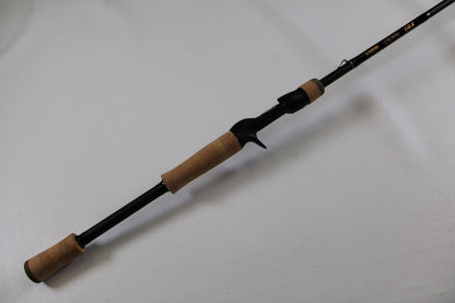 The G. Loomis GLX 873c BJR 7'3" Medium Heavy Used Casting Rod is shown—an excellent-condition black rod with cork grips, ideal for anglers seeking quality pre-owned gear or joining our rod/reel trade-in program.