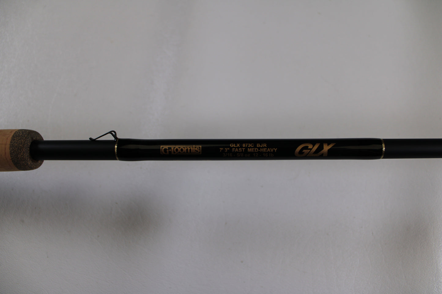 A close-up of a G. Loomis GLX 873c BJR 7'3" Medium Heavy Used Casting Rod in excellent condition, ideal for anglers seeking quality pre-owned gear or those considering a rod trade-in for store credit.