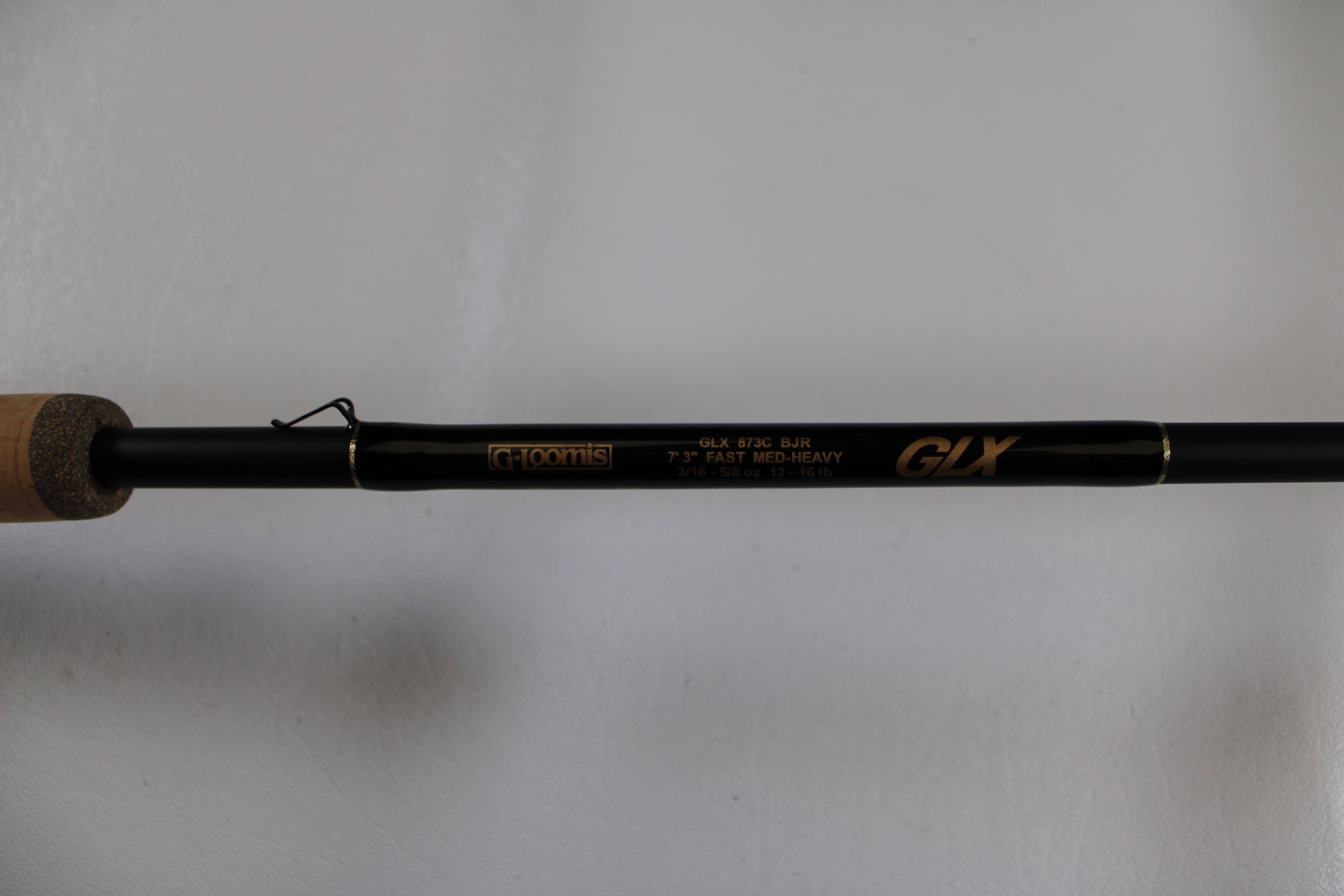 A close-up of a G. Loomis GLX 873c BJR 7'3" Medium Heavy Used Casting Rod in excellent condition, ideal for anglers seeking quality pre-owned gear or those considering a rod trade-in for store credit.