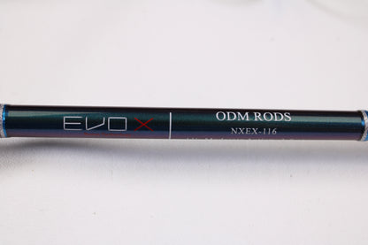 A close-up of the ODM Rods EVO X NXEX-116 11'0" 2pc Used Spinning Rod in excellent condition on a light surface, perfect for those interested in quality used gear or the Rod and Reel Trade-In Program for store credit.