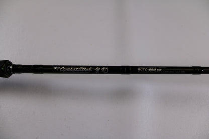 A close-up of the Evergreen Combat Stick RCTC-68M, a used casting rod in excellent condition, shows its model details and "Combat Stick" text on the shaft against a white background—ideal for our Rod and Reel Trade-In Program.
