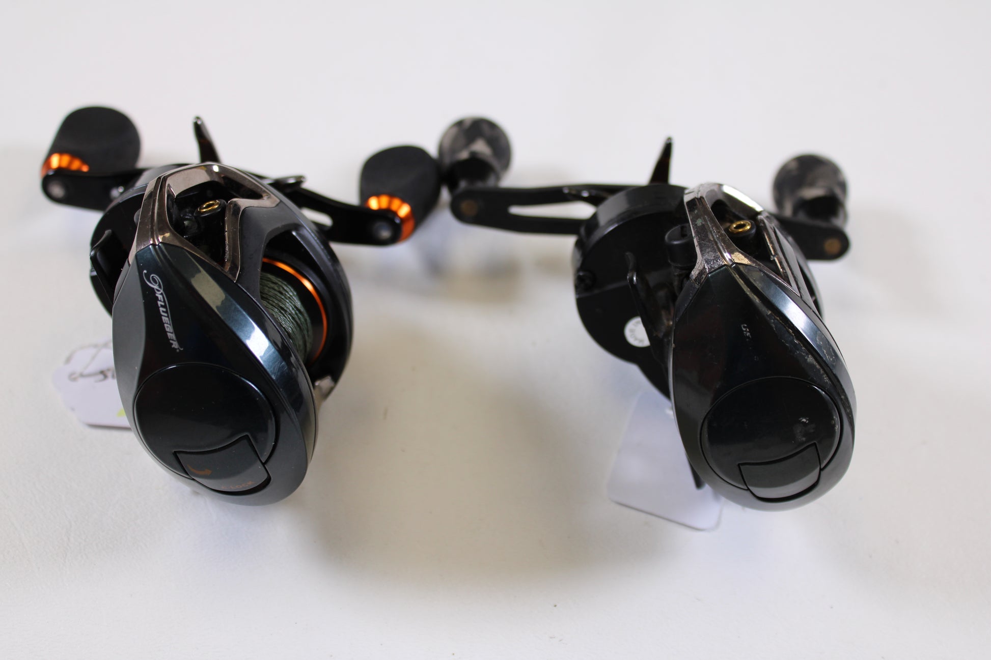 Two used Pflueger Supreme XT casting reels—SUPXT71LP 7.1:1 RH and SUPXT64LP 6.4:1 RH, both in good condition—are shown together, perfect for earning store credit with our Rod and Reel Trade-In Program.