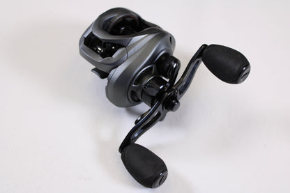 A close-up of the Fitzgerald VLD 10 FVLD-801L 8.1:1 LH—Used Casting Reel in very good condition, showing black and silver design with two large handle grips on a plain white background—ideal for upgrading your fishing gear.