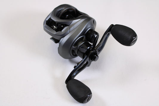 A close-up of the Fitzgerald VLD 10 FVLD-801L 8.1:1 LH—Used Casting Reel in very good condition, showing black and silver design with two large handle grips on a plain white background—ideal for upgrading your fishing gear.