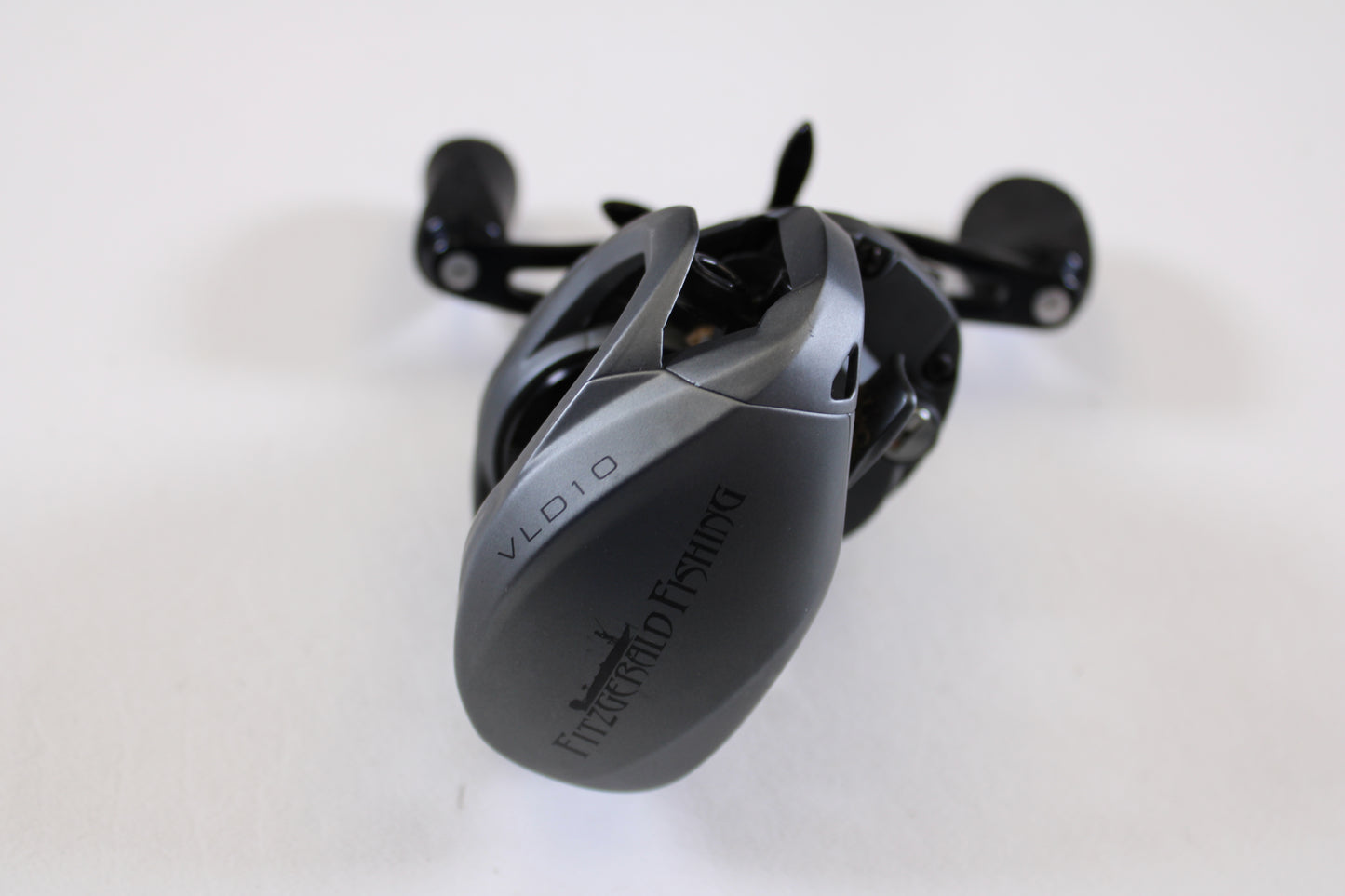 A close-up of a Fitzgerald VLD 10 FVLD-801L 8.1:1 LH used casting reel in very good condition, shown on a white background. Great for anglers looking to trade in or expand their collection of pre-owned Fitzgerald fishing gear.