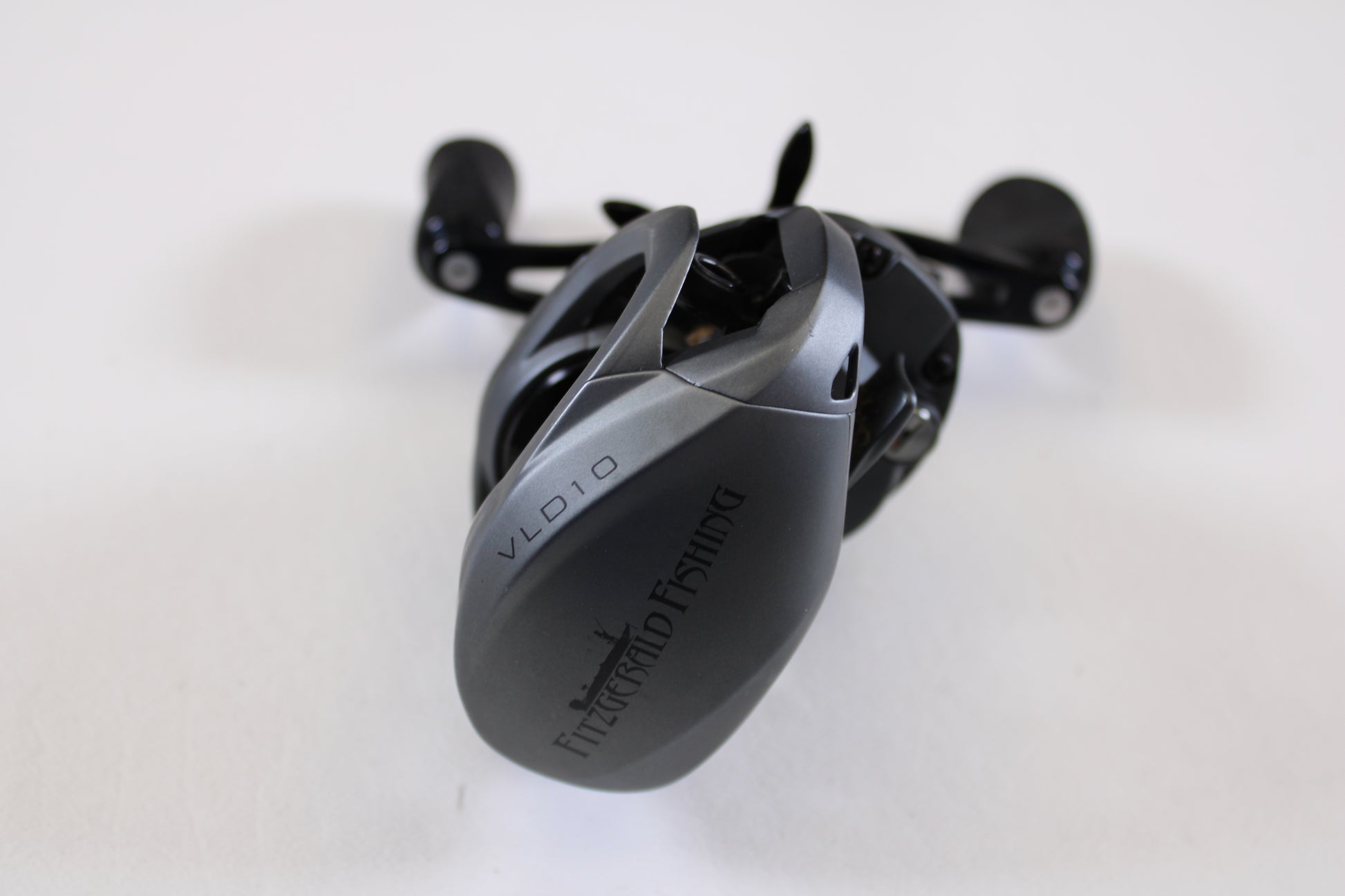 A close-up of a Fitzgerald VLD 10 FVLD-801L 8.1:1 LH used casting reel in very good condition, shown on a white background. Great for anglers looking to trade in or expand their collection of pre-owned Fitzgerald fishing gear.