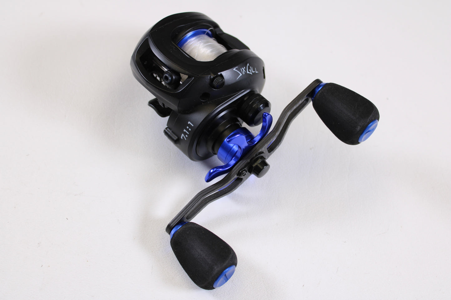 Upgrade your gear with a SixGill Crius 7.1:1 LH Used Casting Reel in excellent condition—black and blue with spool and padded handles. Trade in your old combo through our rod and reel program for store credit!.