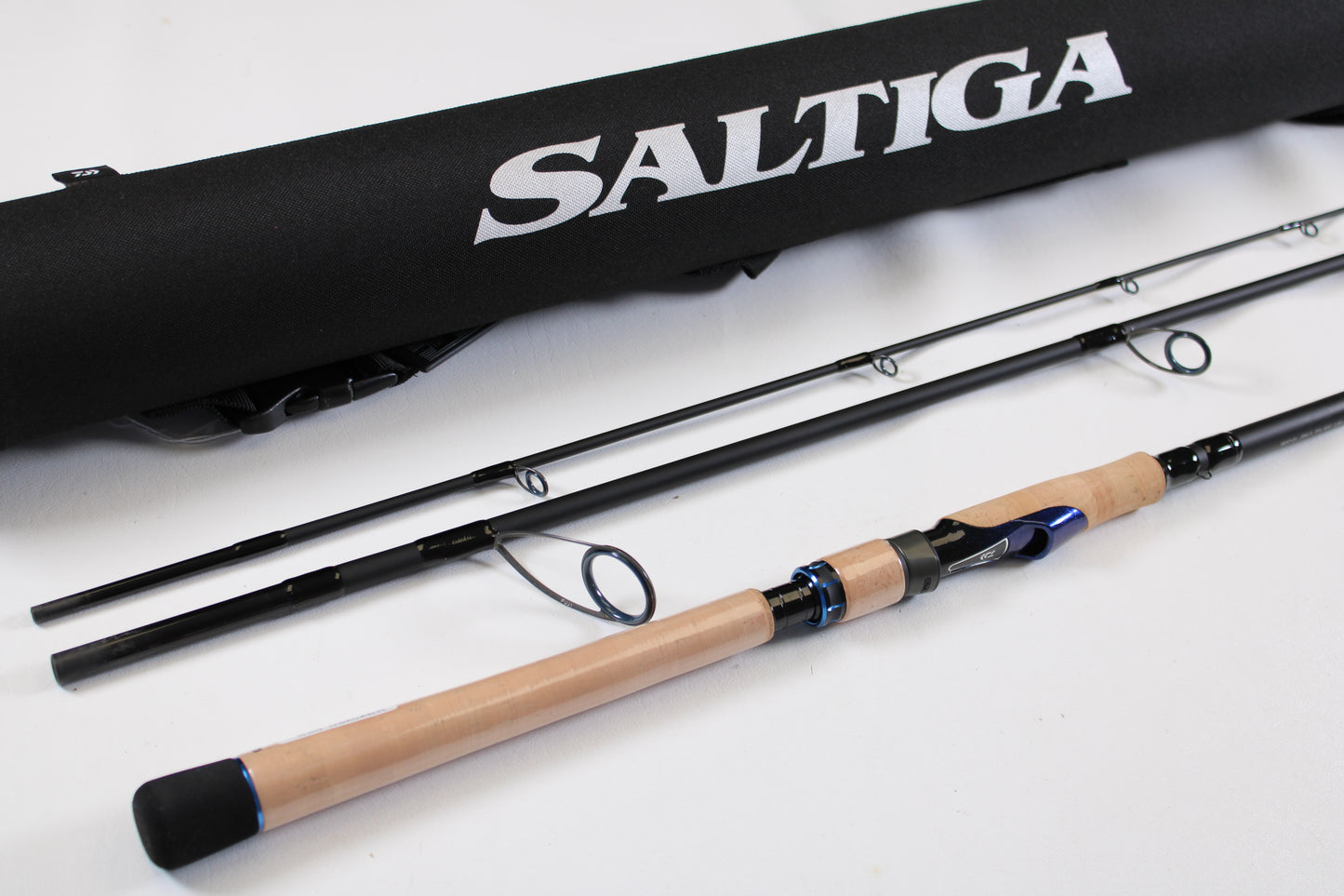 A Daiwa Saltiga Inshore Travel SATRIN703MHFS 7'0" Medium Heavy 3pc used spinning rod (excellent condition) with a black "Saltiga" case is pictured. Trade in your gear for store credit through our Rod and Reel Trade-In Program.