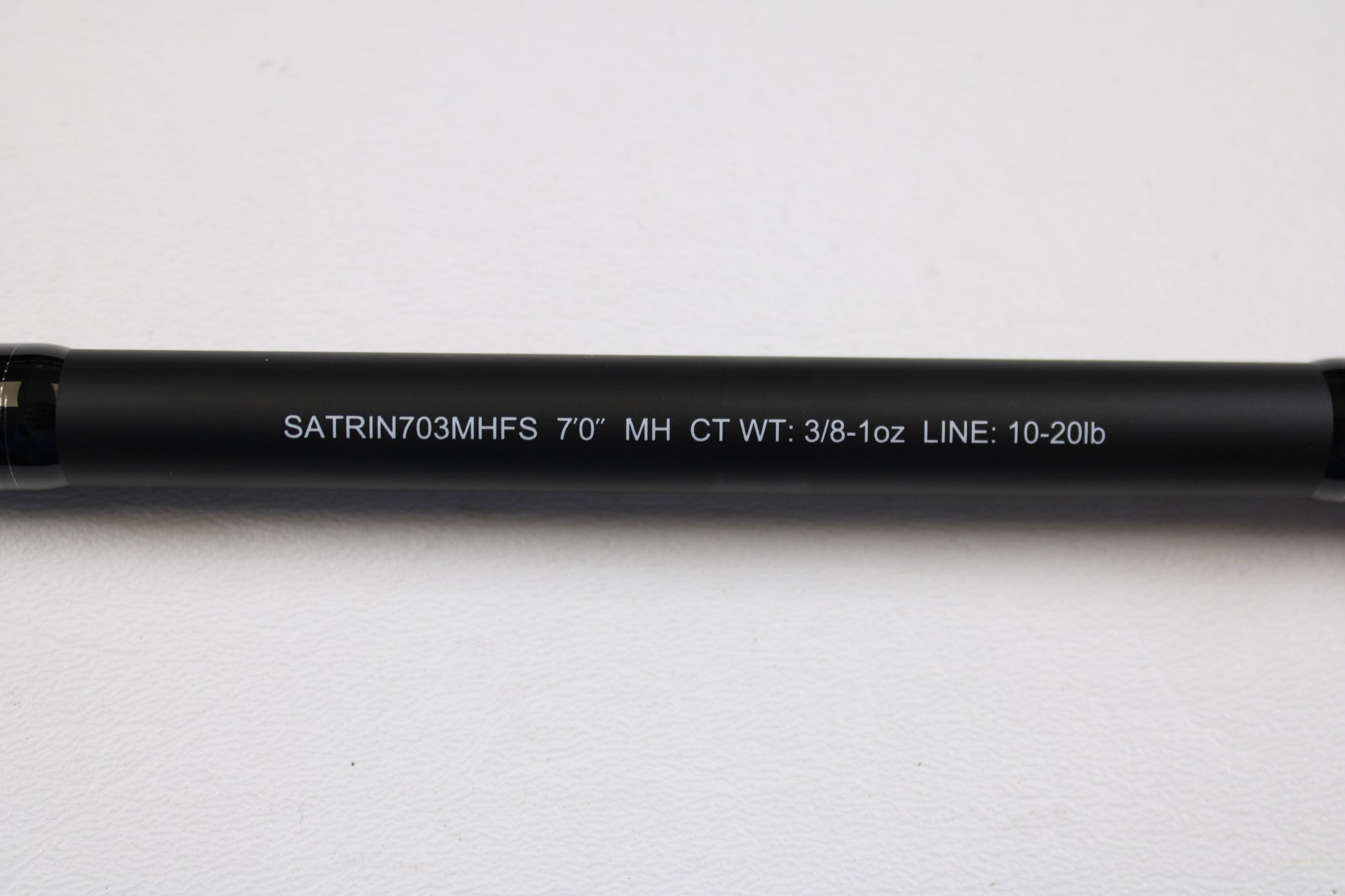 Close-up of a Daiwa Saltiga Inshore Travel SATRIN703MHFS 7'0" medium heavy 3pc spinning rod in excellent condition on white. Ideal for upgrading via our Rod and Reel Trade-In Program; get store credit for your used gear.