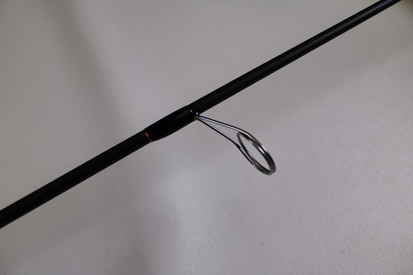 A close-up of the G. Loomis GLX 751s WJR Used Spinning Rod in excellent condition highlights a metal line guide—ideal for those interested in our Rod and Reel Trade-In Program to earn store credit on their used G. Loomis gear.