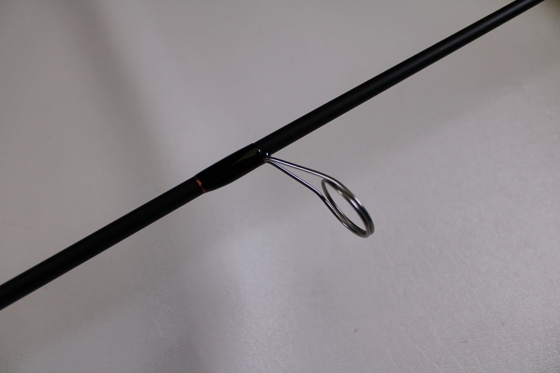 A close-up of the G. Loomis GLX 751s WJR Used Spinning Rod in excellent condition highlights a metal line guide—ideal for those interested in our Rod and Reel Trade-In Program to earn store credit on their used G. Loomis gear.