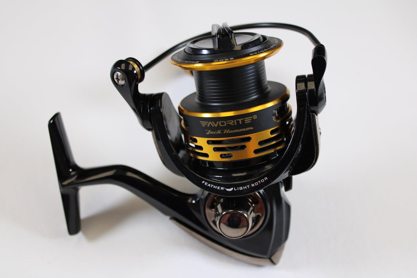 A close-up of a Favorite Fishing Jack Hammer JHM2500 5.2:1 spinning reel in excellent used condition is shown on a white background—ideal for those seeking quality used gear or joining our rod and reel trade-in program.
