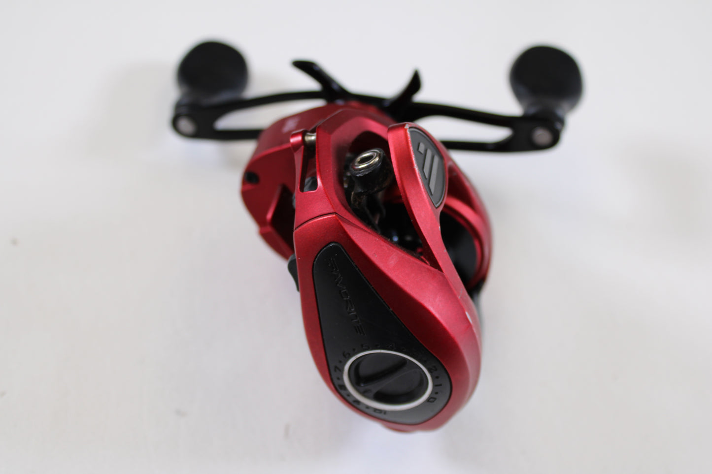 A close-up of the Favorite Fishing Soleus Red SLSR7R 7.3:1 RH Used Casting Reel in good condition, featuring black handles—ideal for our Rod and Reel Trade-In Program or anyone seeking quality pre-owned gear.