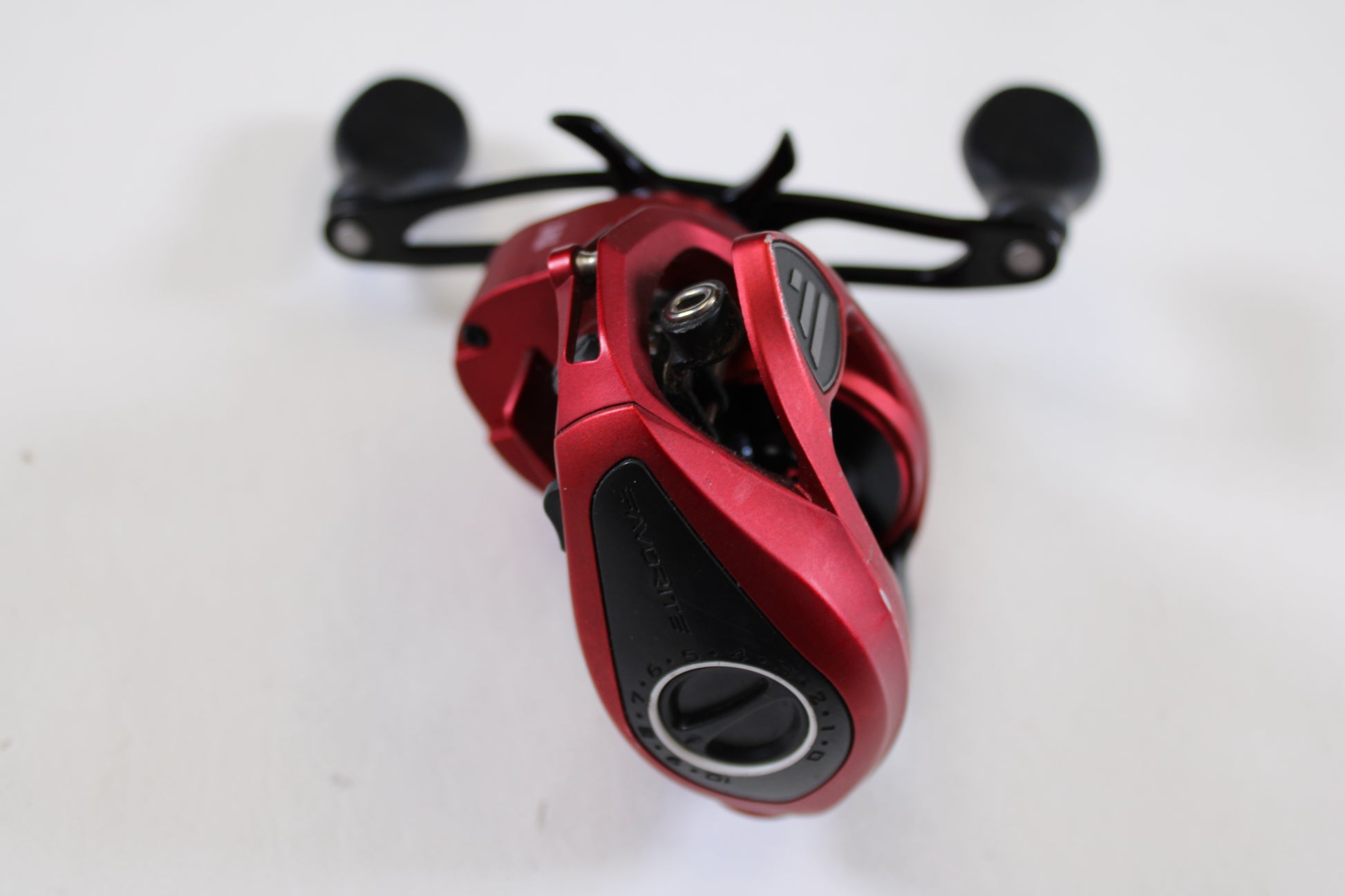 A close-up of the Favorite Fishing Soleus Red SLSR7R 7.3:1 RH Used Casting Reel in good condition, featuring black handles—ideal for our Rod and Reel Trade-In Program or anyone seeking quality pre-owned gear.