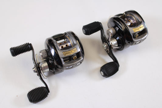 Two used Bass Pro Shops Johnny Morris JMX10HD 6.4:1 RH casting reels, qty 2, in good condition with dual handles and ribbed grips; ideal for trade-in or store credit.