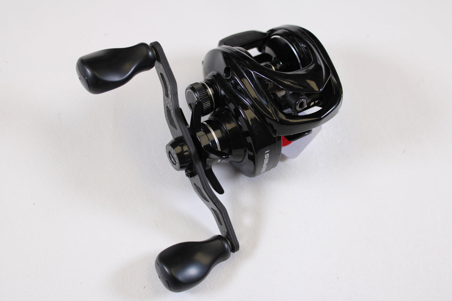 A used Kistler Series 1 KS1-R173 7.3:1 RH casting reel in good condition, featuring dual handles and a glossy black finish, available through our rod and reel trade-in program. Shown on a plain white background.