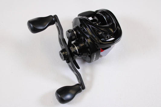 A used Kistler Series 1 KS1-R173 7.3:1 RH casting reel in good condition, featuring dual handles and a glossy black finish, available through our rod and reel trade-in program. Shown on a plain white background.