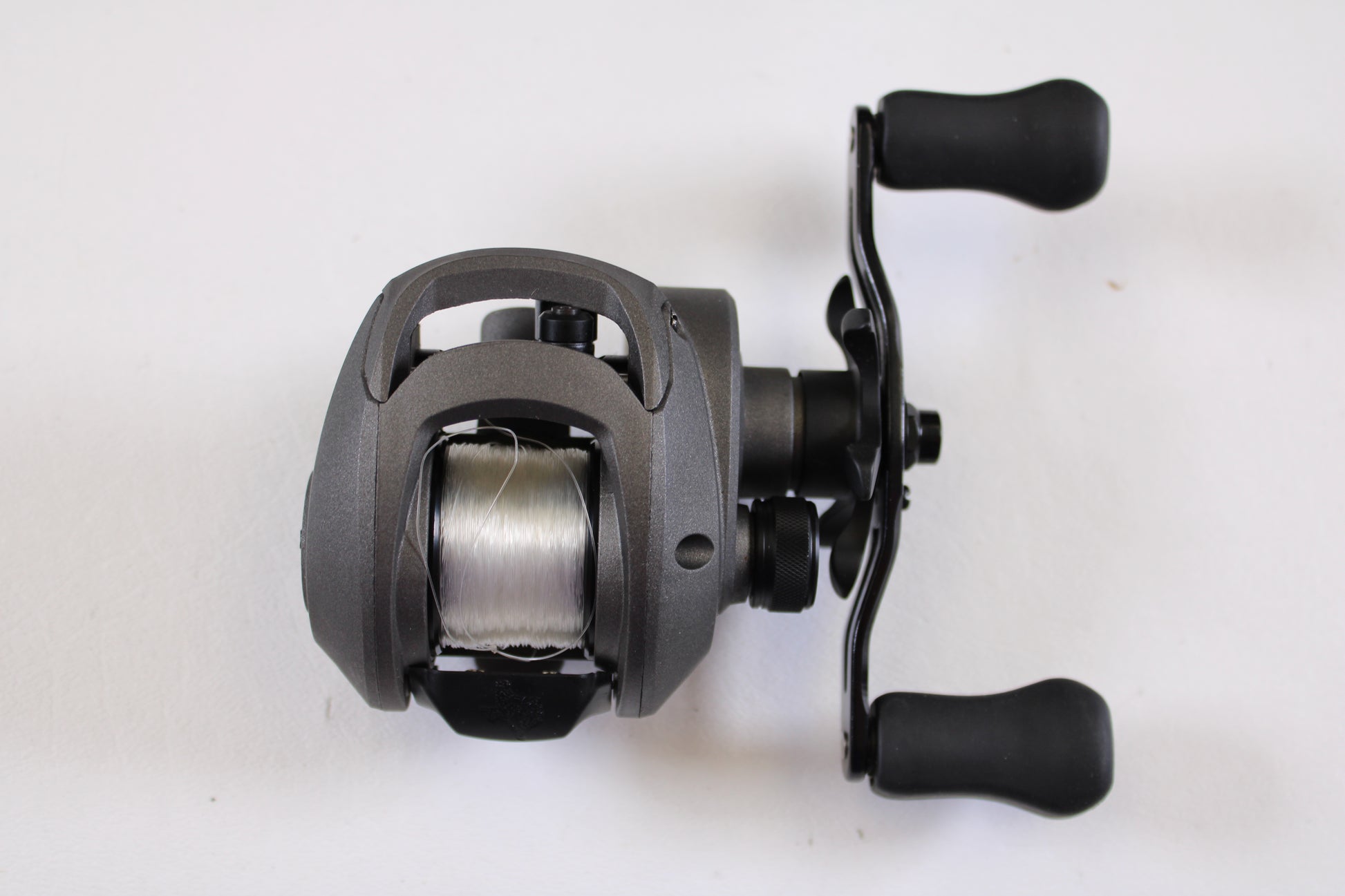 The SixGill Arrival Series 6 7.0:1 RH Used Casting Reel features a sleek black design with dual handles and comes in excellent condition—perfect for the Rod and Reel Trade-In Program if you want to upgrade your gear.