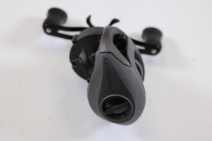A close-up of a SixGill Arrival Series 6 7.0:1 RH Used Casting Reel in excellent condition, featuring a sleek, ergonomic black design—ideal for our Rod and Reel Trade-In Program or earning store credit on used gear.