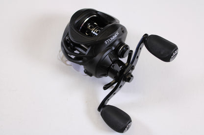 A Fitzgerald Stunner 6.3:1 LH used casting reel in excellent condition, featuring dual ergonomic handles, shown on a plain white surface—ideal for upgrades with our rod and reel trade-in program.