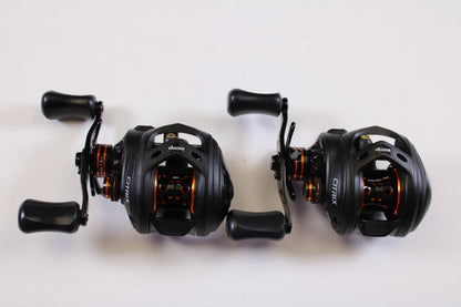Two Okuma Citrix Ci-273LXa 7.3:1 LH used casting reels (Qty: 2, very good condition) rest side by side—great for trading in or earning store credit with our rod and reel trade-in program.