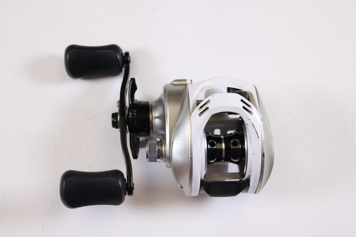 The Okuma Stratus V 6.4:1 LH Used Casting Reel in good condition is shown on a white background—ideal for anglers upgrading their gear with our rod and reel trade-in program.