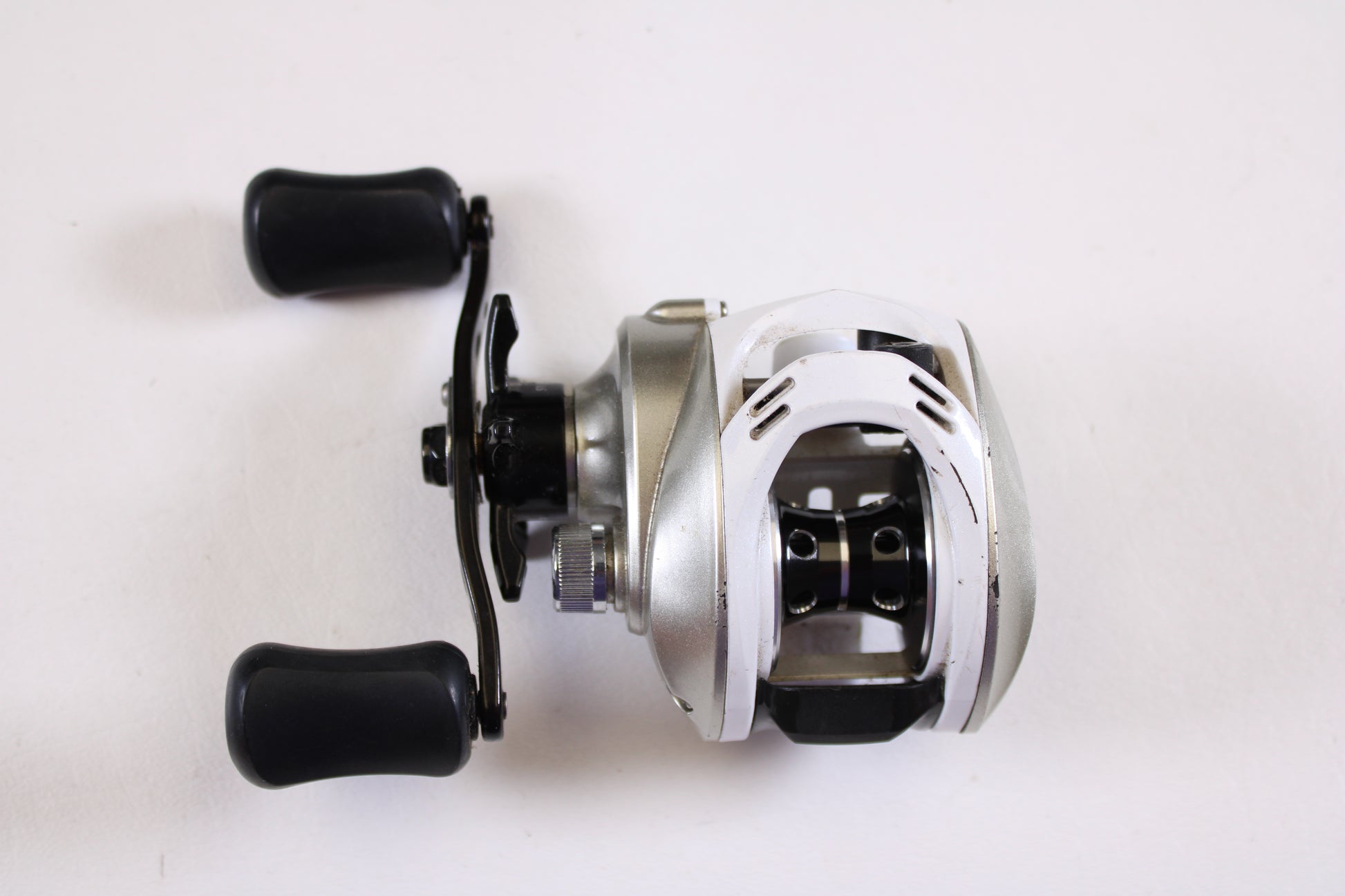 The Okuma Stratus V 6.4:1 LH Used Casting Reel in good condition is shown on a white background—ideal for anglers upgrading their gear with our rod and reel trade-in program.